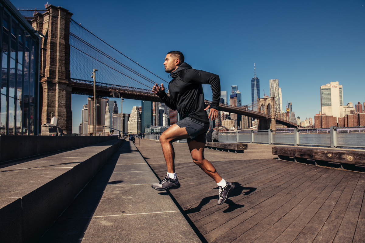 Athelte man running in New York City street wearing sport clothes
